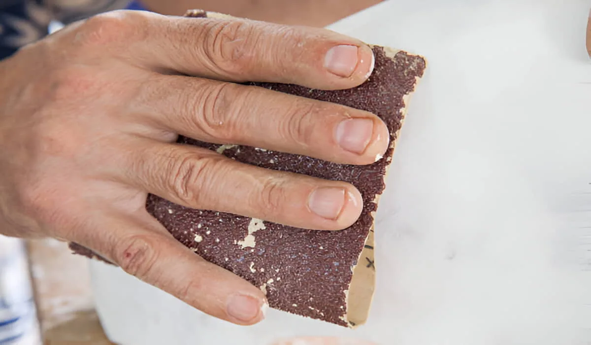 polish marble with sandpaper